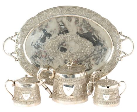 AN INDIAN SILVER REPOUSSE TEA SERVICE, EARLY 20TH C  of lidded, tapered oval form with  continuous  jungle scenes with wild a