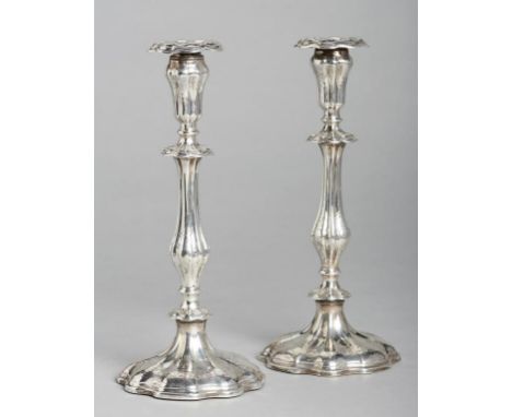 A PAIR OF VICTORIAN SILVER CANDLESTICKS of lobed form, engraved with scrolling foliage, nozzles,  29.5cm h, by Henry Wilkinso