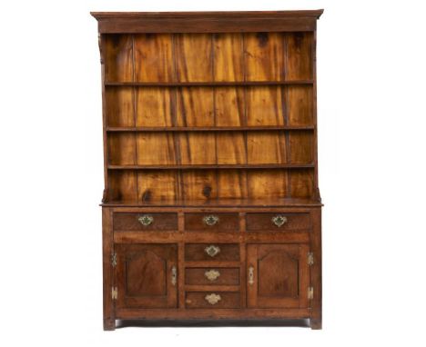 AN OAK DRESSER, NORTH WALES, FIRST HALF 19TH C  with a boarded three shelf rack, fitted with drawers and enclosed by ogee pan