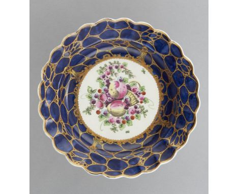 A WORCESTER GROS BLEU GROUND PLATE, C1775-78  painted to the centre with a group of spotted fruit in   caillouté border and s
