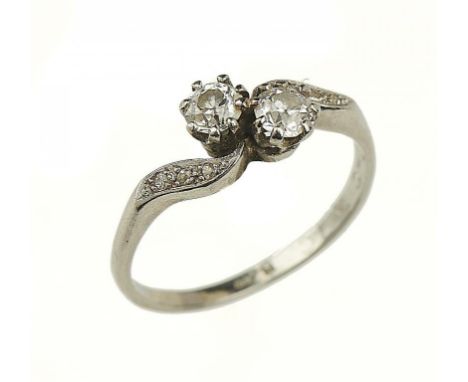 A DIAMOND CROSSOVER RING   with diamond shoulders in platinum marked PLAT, 3.9g, size Q++Typical light wear to hoop