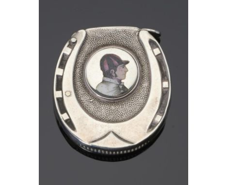 A VICTORIAN SILVER AND ENAMEL HORSESHOE NOVELTY VESTA CASE  the front applied with a roundel of the head of jockey, 4cm h, by