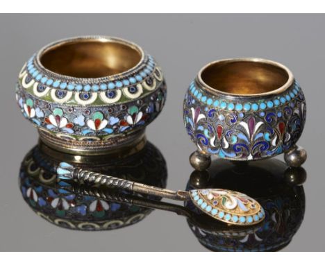 TWO RUSSIAN SILVER GILT AND CLOISONNE ENAMEL SALT CELLARS AND A SALT SPOON  largest salt 47cm diam, Cyrillic  maker's marks, 