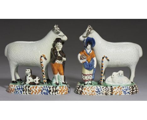 A PAIR OF PRATTWARE GROUPS OF A RAM WITH GARDENER AND SHEPHERDESS, C1800-20  on blue, brown and ochre sponged mound with dog 