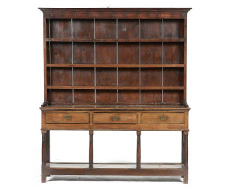 A GEORGE III OAK DRESSER, EARLY 19TH C  the three shelf boarded rack on open base with three drawers and pot board, 206cm h; 