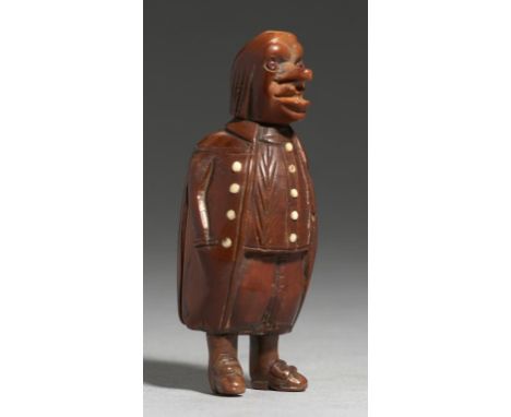 TREEN. A CARVED COQUILLA NUT SNUFF BOX IN THE FORM OF A GROTESQUE MAN, GERMAN OR DUTCH, EARLY 19TH C  with vegetable ivory co