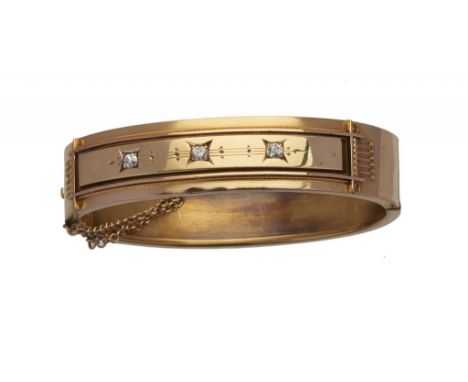 A VICTORIAN DIAMOND BANGLE, LATE 19TH C the central rectangular tablet with three gipsy set diamonds, in gold, 56 x 61mm, 19g