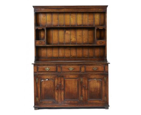 AN OAK DRESSER, 20TH C  the boarded rack with spice drawers, the lower part with moulded drawers and panelled doors, 187cm h;