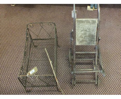 A vintage iron dolls cot plus a wooden pushchair