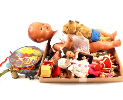 A collection of various sized dolls, tambourine, two die cast figures, stuffed bear etc