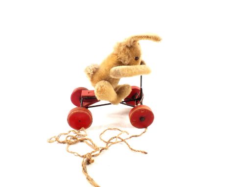 A Steiff plush rabbit on pull along cart