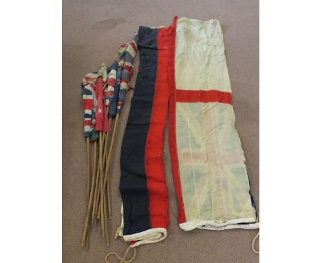 A quantity of various vintage flags some on 'poles'