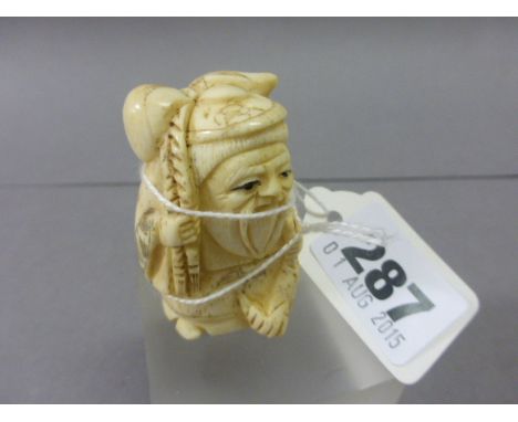 Signed Oxbone Netsuke of an Old Man with Fish