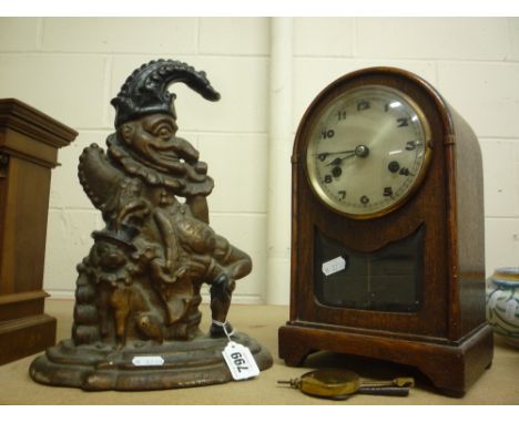 A CAST 'PUNCH' DOORSTOP, and a mantel clock (key and pendulum)