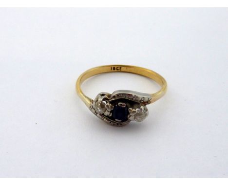 AN 18CT GOLD SAPPHIRE AND DIAMOND RING, the circular sapphire with old cut diamonds flanking either side, to the twisted shan