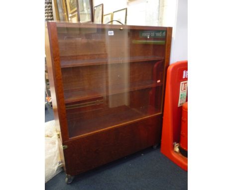 A WOODEN THREE SHELF PORTABLE DISPLAY CASE, with detachable wheeled storage unit to bottom, height approximately 95cm, width 