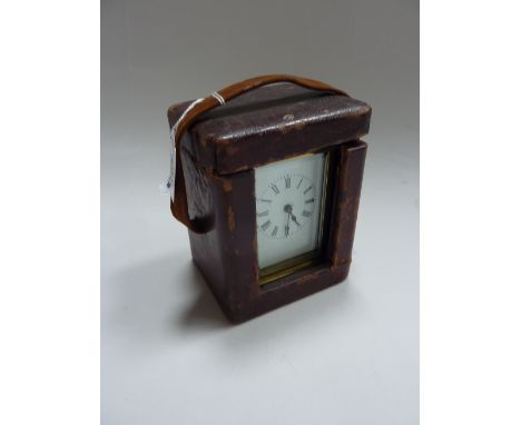 A BRASS CARRIAGE CLOCK, in travelling case