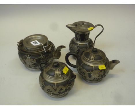 A CHINESE PEWTER MOUNTED STONEWARE FOUR-PIECE TEA SERVICE, Tung King Shun factory, the black stoneware mounted with dragons a