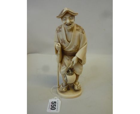 A JAPANESE CARVED IVORY FIGURE OF A STREET VENDOR, Meiji period, possibly Tokyo School, modelled standing in rustic robes, ha