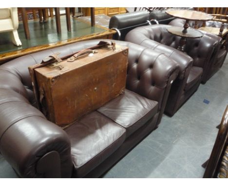 A BROWN LEATHER CHESTERFIELD STYLE THREE PIECE SUITE, comprising of a two seater sofa and two armchairs