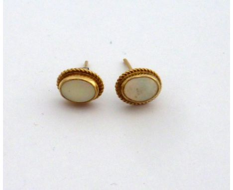 A PAIR OF OPAL STUD EARRINGS, with rope twist surrounds