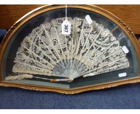 A VINTAGE FAN, with delicate lace work and mother of pearl handle within a frame