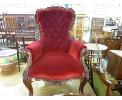 A VICTORIAN MAHOGANY FRAMED BUTTON BACK ARMCHAIR, with red upholstery