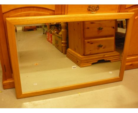 AN ERCOL BLONDE ELM FRAMED WALL MIRROR