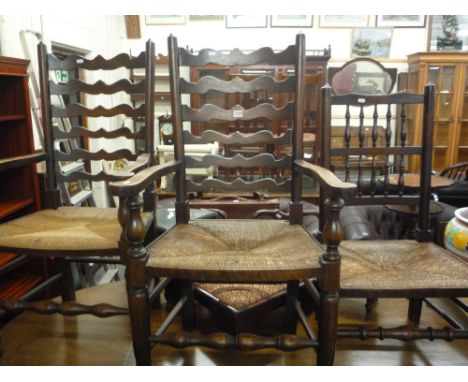 A PAIR OF LADDER BACK RUSH SEATED ARMCHAIRS, and another rush seated chair (3)