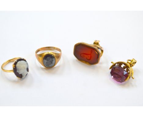 FOUR ITEMS, to include two fobs and two rings, a swivel amethyst fob and a cornelian fob, together with an intaglio signet ri