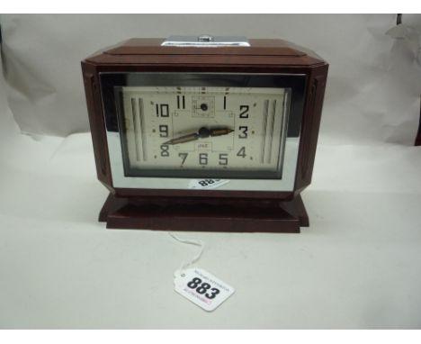 AN ART DECO JAZ RED BAKELITE ALARM CLOCK, (situated in brown cabinet)