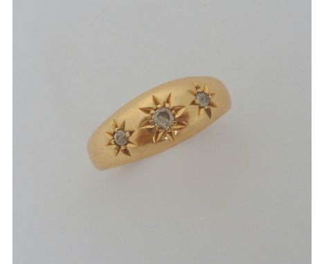 AN 18CT GOLD GYPSY RING, with three old cut diamonds within star shape engraving to the domed plain tapered sides, hallmarks 