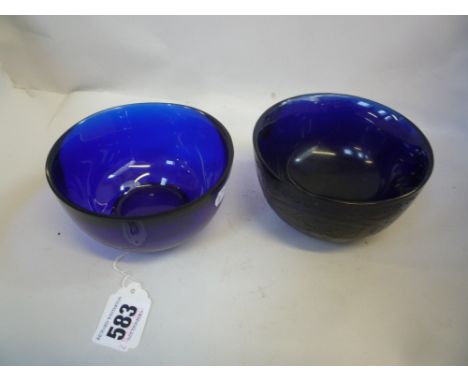 TWO CHINESE BLUE GLASS BOWLS, in the 18th Century manner but probably Republic, plain rounded form on ring feet, one engraved
