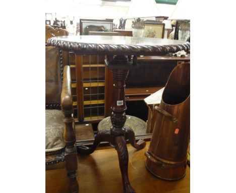 A MODERN CIRCULAR CARVED MAHOGANY TILT TOP TRIPOD TABLE