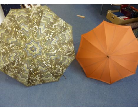 TWO UMBRELLAS, the first a Pierre Cardin leopard print umbrella, together with a further vintage umbrella with celluloid hand