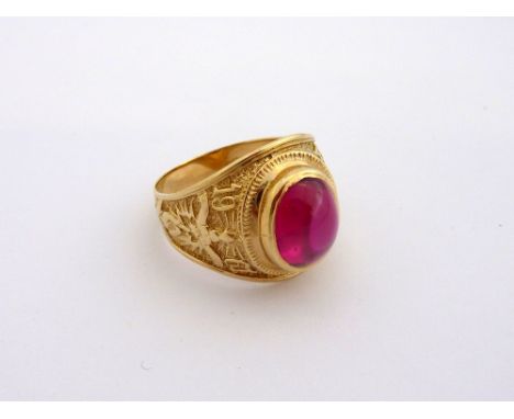 A 9CT GOLD COLLEGE RING, with central ruby coloured stone, to the fancy scrolling sides, hallmarks for Birmingham, ring size 