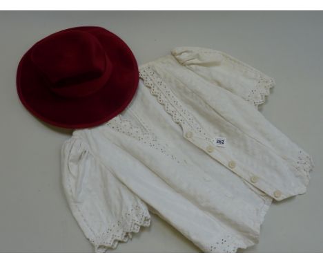 TWO ITEMS OF VINTAGE CLOTHING, to include a red Jacksons hat and a cropped white lace jacket (2)
