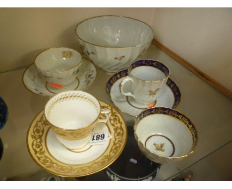 A GROUP OF FLIGHT WORCESTER PORCELAIN, c.1800 of spiral fluted form comprising two tea bowls and saucers, coffee cup and slop