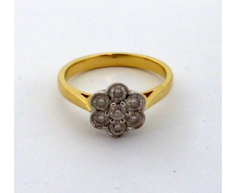 AN 18CT GOLD DIAMOND CLUSTER DAISY SHAPED RING, with brilliant cut diamonds, estimated total diamond weight 0.35cts, hallmark