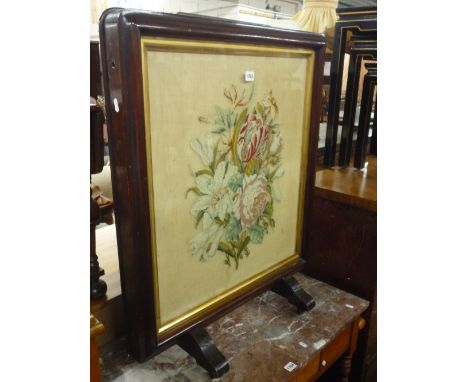 A VICTORIAN ROSEWOOD FIRESCREEN, with needlework inset panel