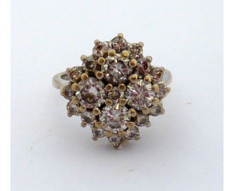A DIAMOND RING, with central brilliant cut diamond surrounded by four larger brilliant-cut diamonds forming a cross-shape to 
