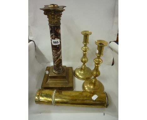 A PAIR OF BRASS CANDLESTICKS, a single candlestick and brass cased measuring item (4)