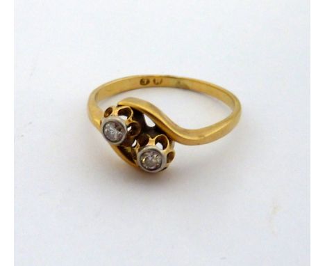 A DIAMOND RING, two brilliant cut diamonds within scalloped surrounds to the twisted shank, hallmarks rubbed, ring size M