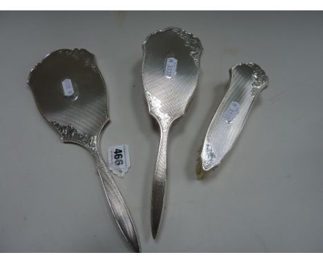 A SILVER THREE PIECE DRESSING TABLE SET, Birmingham 1996, engine turned and floral decoration (3)