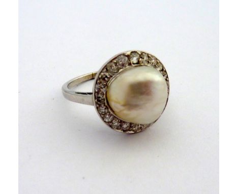 A PEARL AND DIAMOND RING, the central pearl within a surround of old cut diamonds, pearl dimensions 11mm x 6mm approximately,
