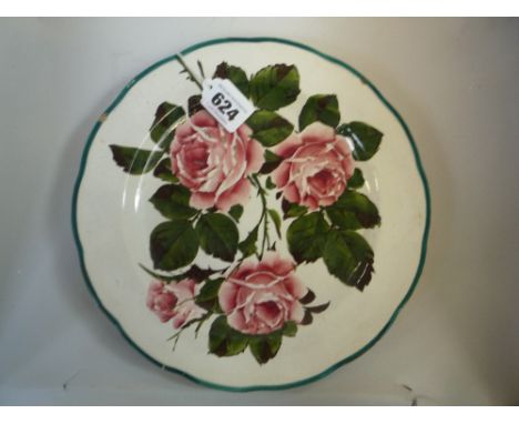 A WEMYSS STYLE PLATE, decorated with roses and green leaves, unmarked, diameter 24.5cm