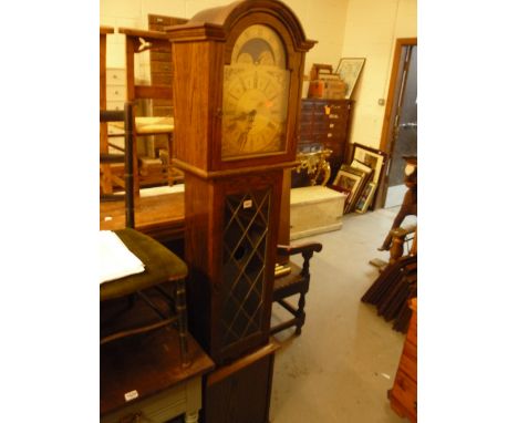 A MODERN OAK LONGCASE CLOCK, with leaded glass door, pendulum and three brass weights, face marked Fenclocks Suffolk (s.d. Le