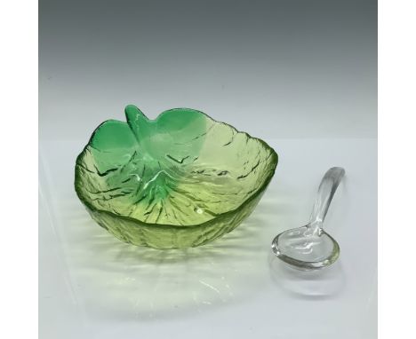 This elegant 2-piece set includes a green glass leaf-shaped dish and a matching clear glass spoon. The dish features vibrant 