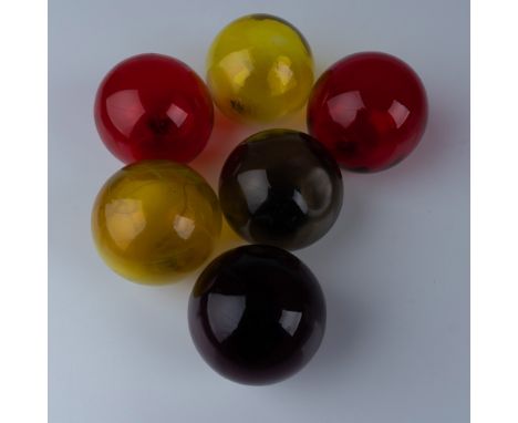 This set features six beautifully crafted blown glass spheres, each with a rich, translucent color, including red, yellow, an