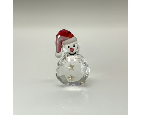 Adorable clear crystal smiling snowman figure with red accents on its cap and nose. Swarovski swan mark. This item includes a